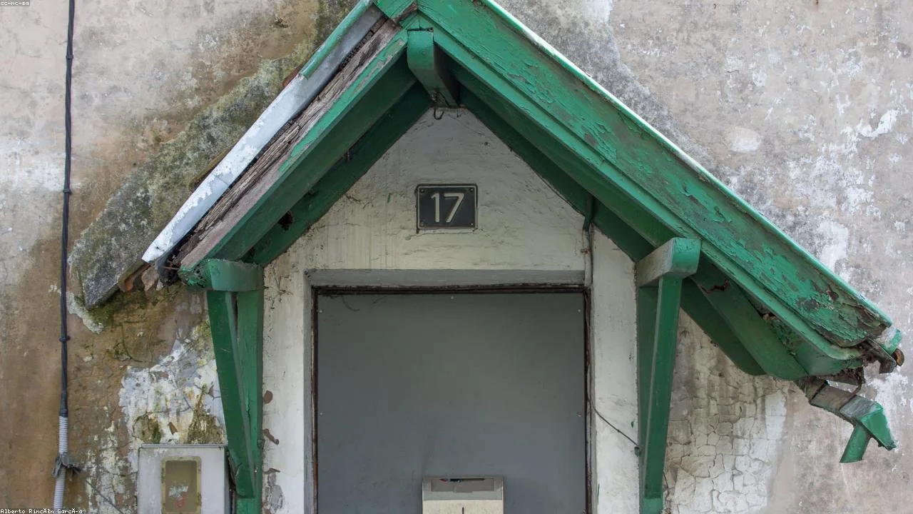 Person checking an electronic locking mailbox on a front porch